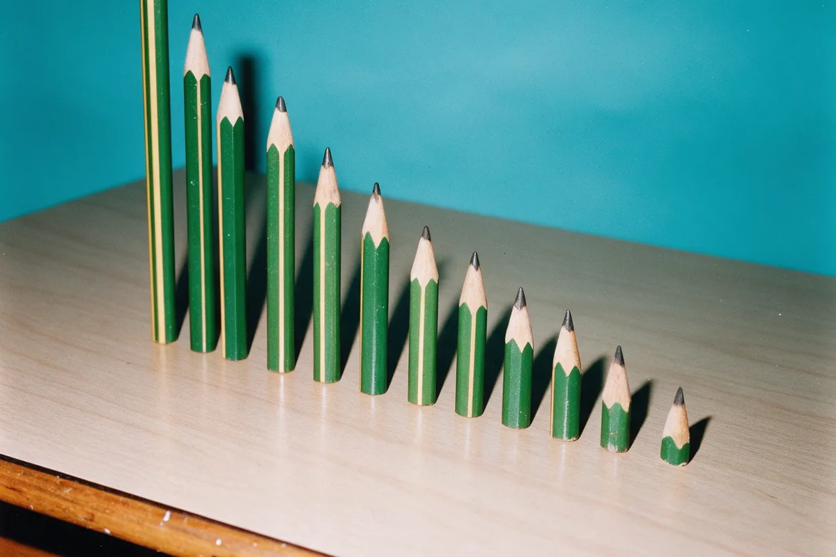 Pencils worn down to different lengths, lined up on a desk